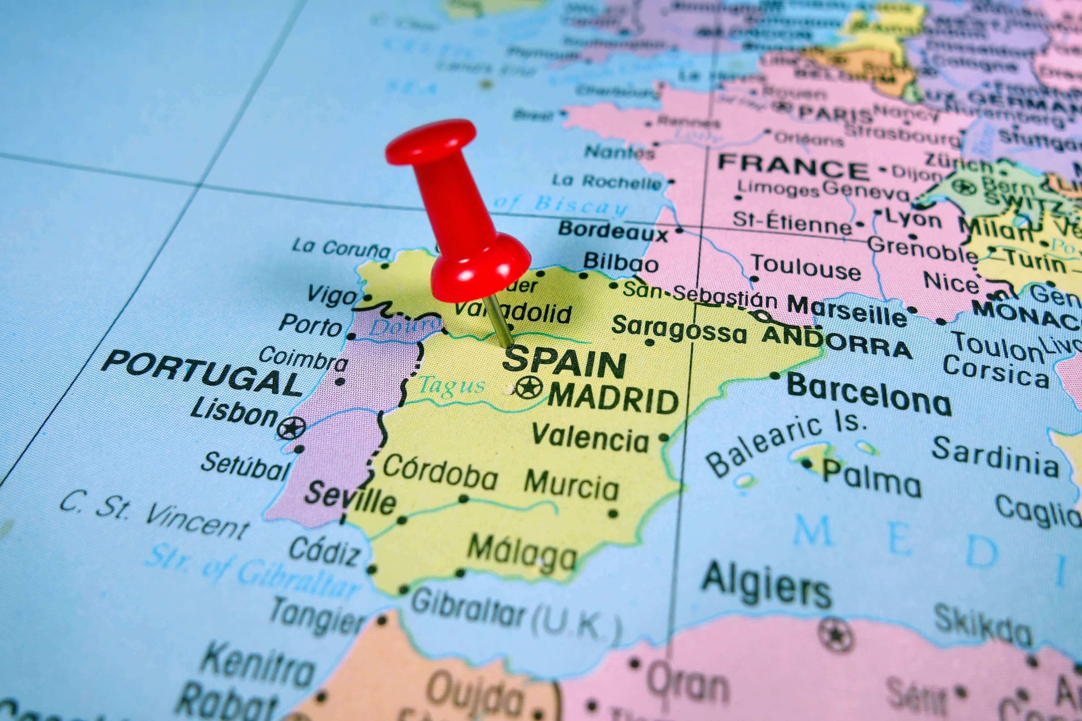 Close-up map of Spain with a pushpin marking Madrid’s location.